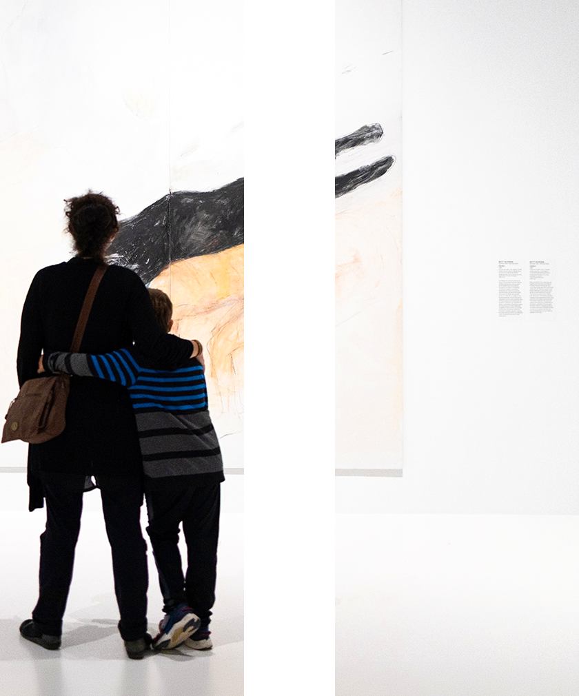 mage shaped like a pause symbol featuring a mother and her child looking at an artwork.